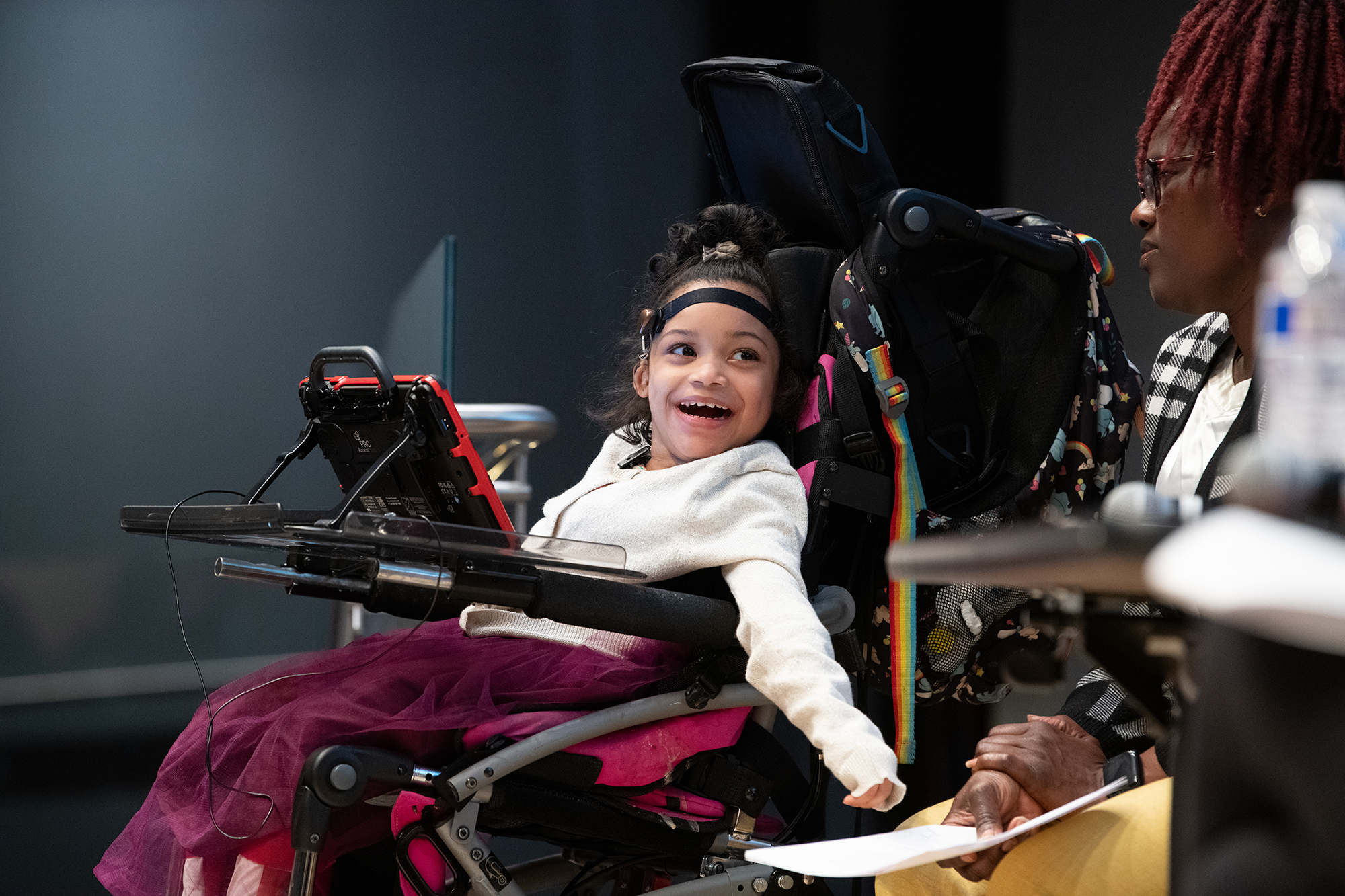 A child smiling in a wheel chair