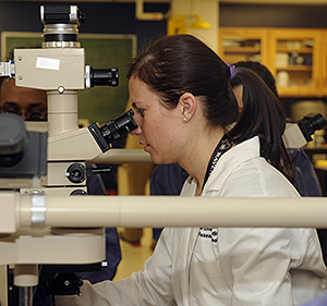 Female student looking in a microscope