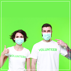 man and woman with volunteer on tshirts