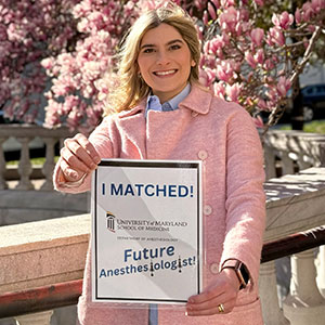 Resident holding a sign that says I matched