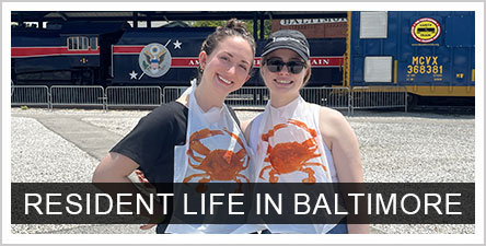 Resident Life in Baltimore: Two residents with crab eating bibs