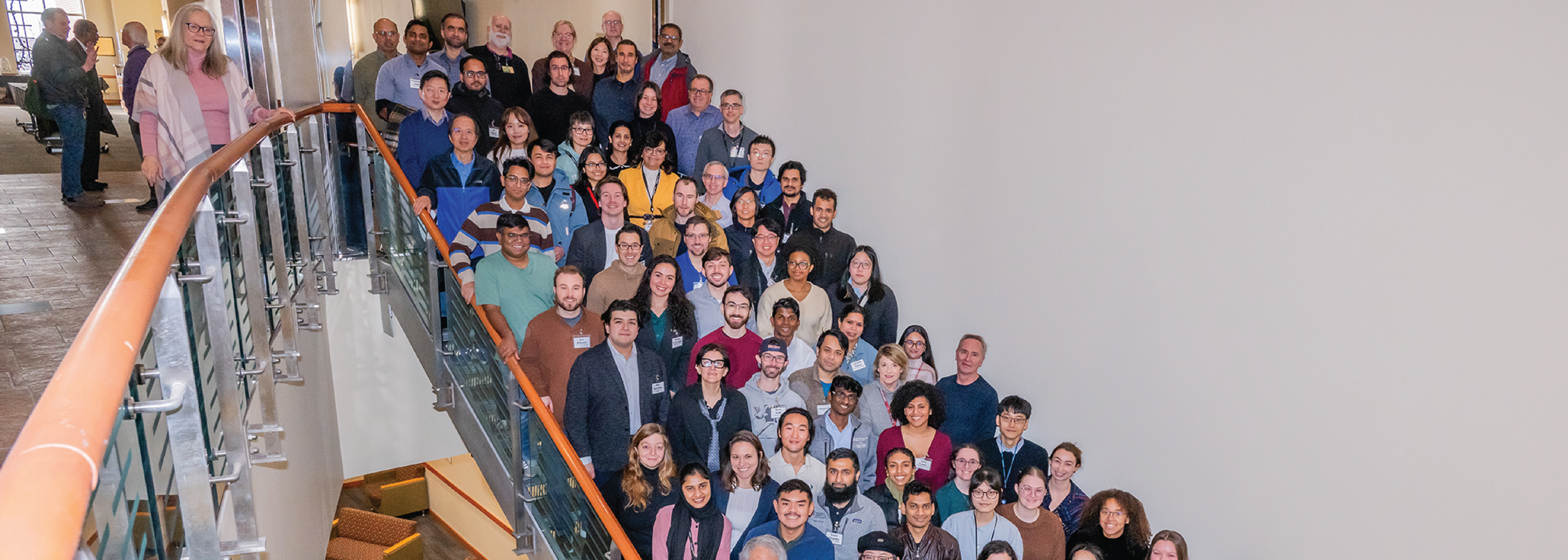 A crowd of people posing on the a staircase