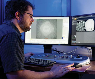 Man looking at CryoEM workstation 