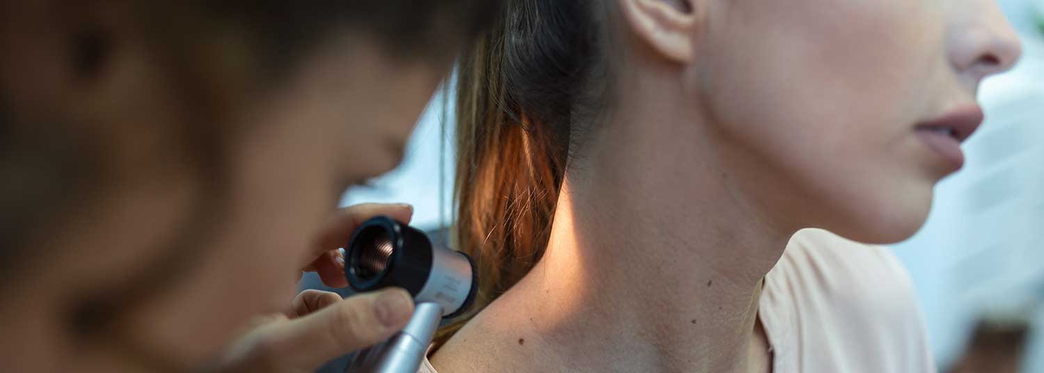 Dermatologist examining a patients neck