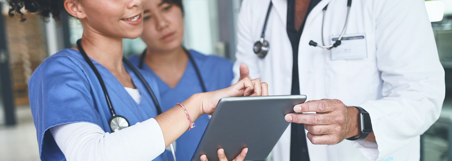 Group of physicians looking at an electronic tablet