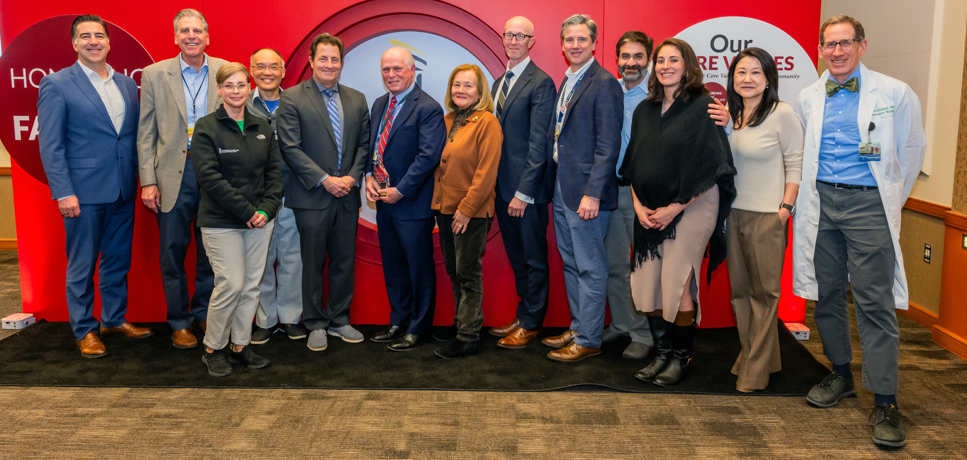 Group of UMSOM EM physicians surrounding longtime Department Chair, Dr. Brian Browne.