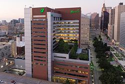 Photo of Mercy Medical Center in downtown Baltimore. Includes rooftop patio area overlooking tree-line boulevard.