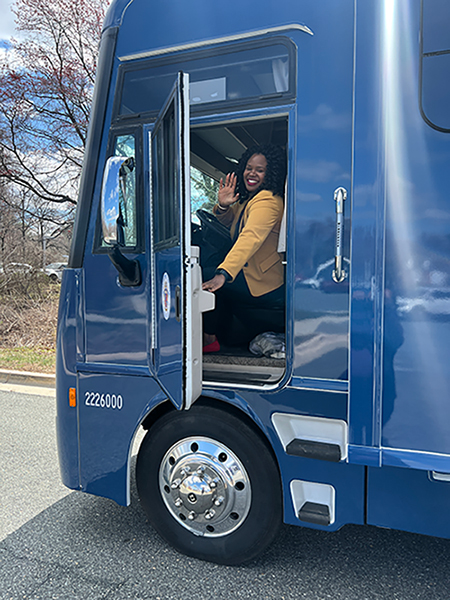 Felicia Hugee, MPH, PMP, Class of 2013, sits in the driver's seat of Montgomery County's Mobile Health Clinic