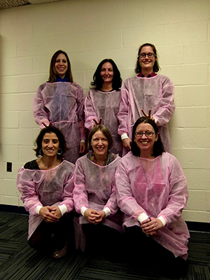 Six researchers at a kickoff meeting for a study on gowns and gloves