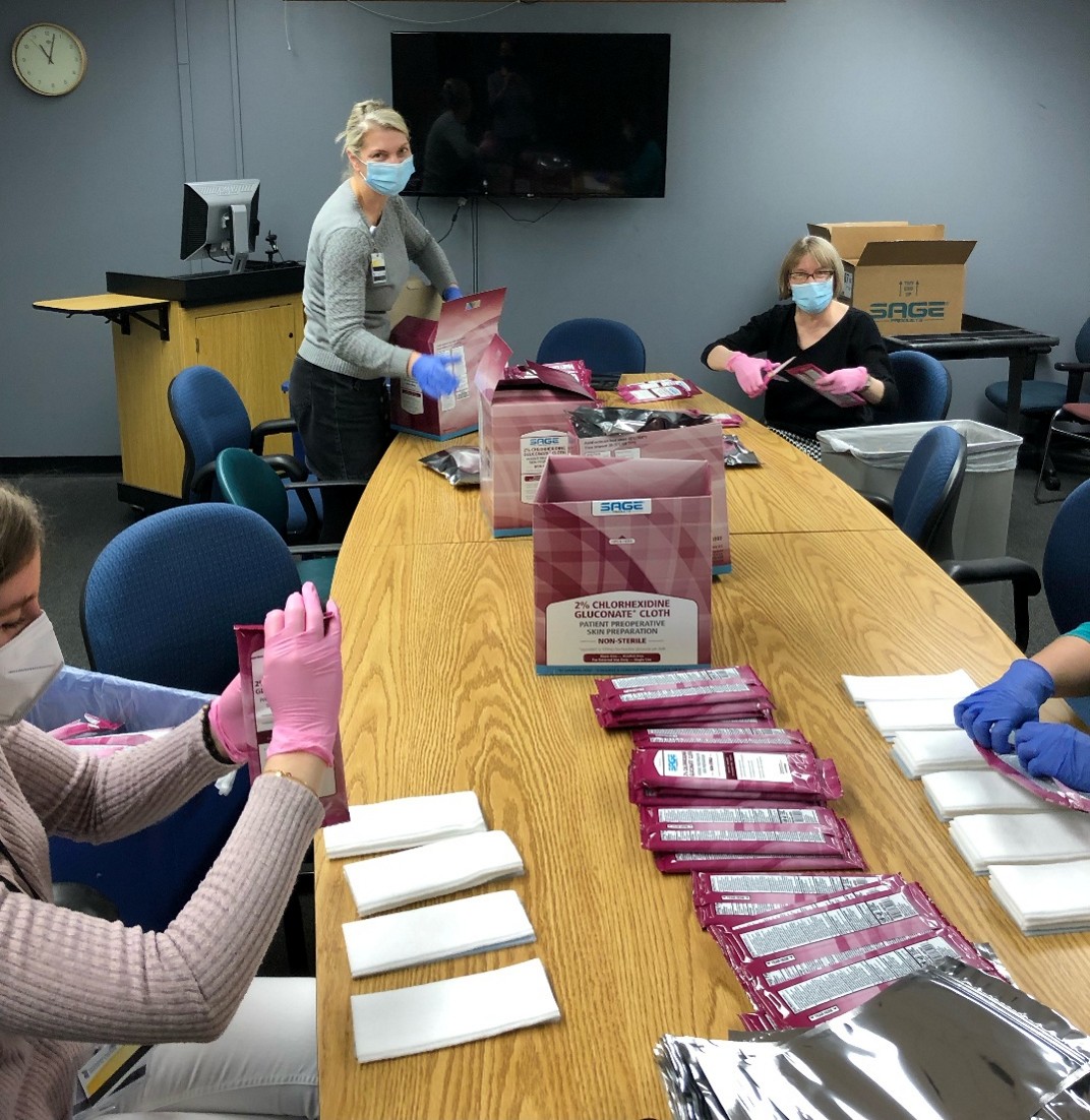 people sitting around a table packing supplies
