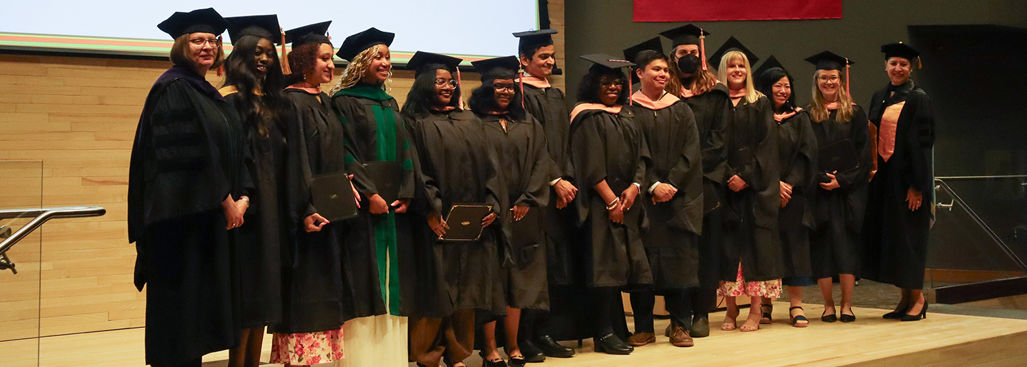 Spring 2026 Master of Public Health pose at graduation