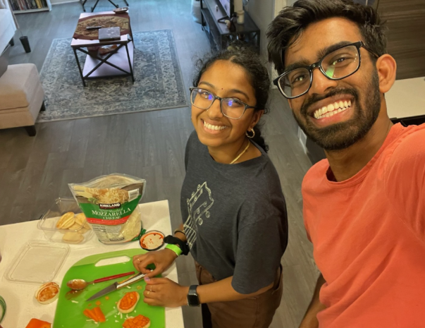 Akshaya Balaji and her partner pose as they make food