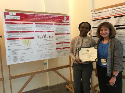 Student receives certificate from Dr. Beth Barnet for poster presentation at Primary Care Day.