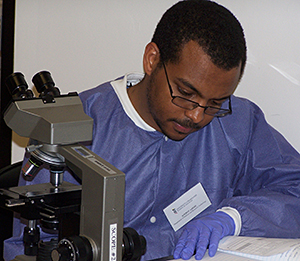 Student with microscope writing