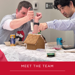 Two faculty building a gingerbread house together