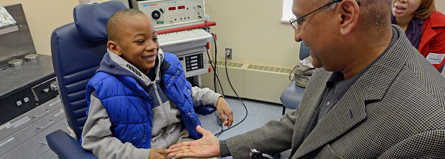 Physician treating pediatric patient