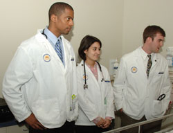 Three med students at patient bedside