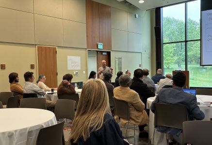 Faculty member shares a presentation with the group during the retreat.