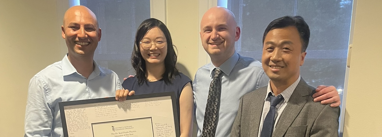 Medical physics residents presenting the physics award at graduation dinner to Naru, left to right: Naru Lamichhane, Juan Chen, Tommy Stasko, Yufeng Cao