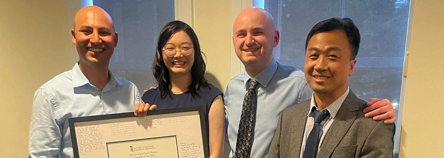 Medical physics residents presenting the physics award at graduation dinner to Naru, left to right: Naru Lamichhane, Juan Chen, Tommy Stasko, Yufeng Cao