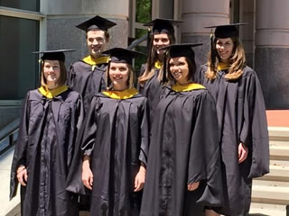 2015 graduates outside of building