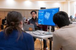 A ThermoFisher representative presents their software to a small group of attendees