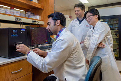 Three researchers in lab