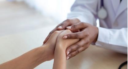 Healthcare provider comforting a patient
