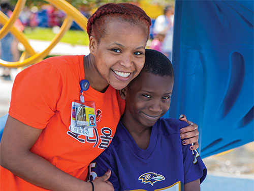 Happy caregiver and child at event