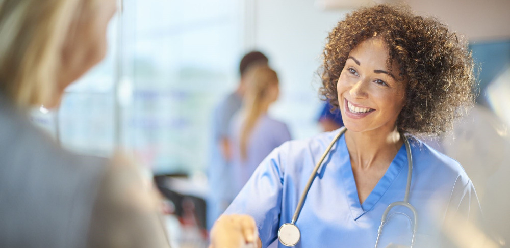 Young female doctor greeting a female patient