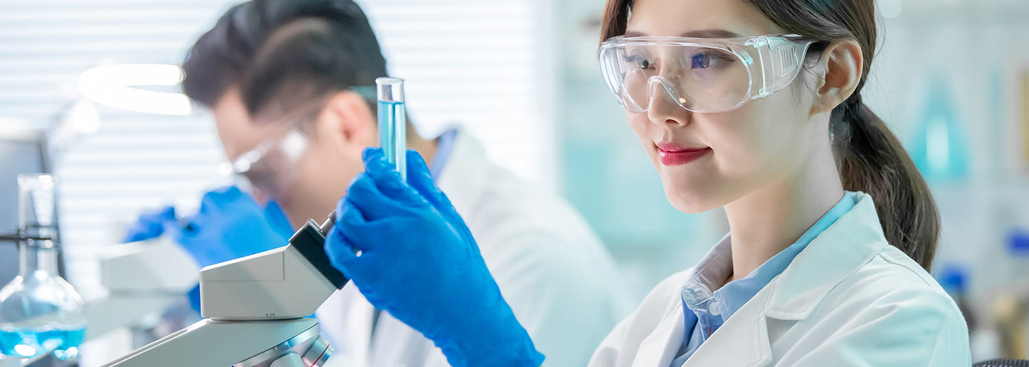 Asian science researcher with test tube