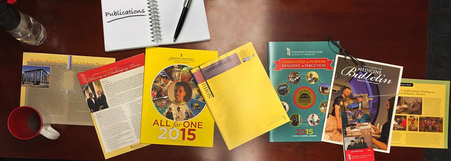UMSOM publications layed out on a desk