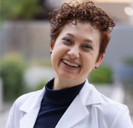 Woman in a white coat smiling