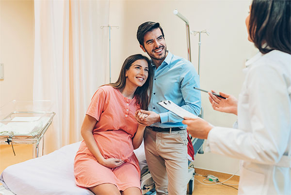 Pregnant couple at provider's office