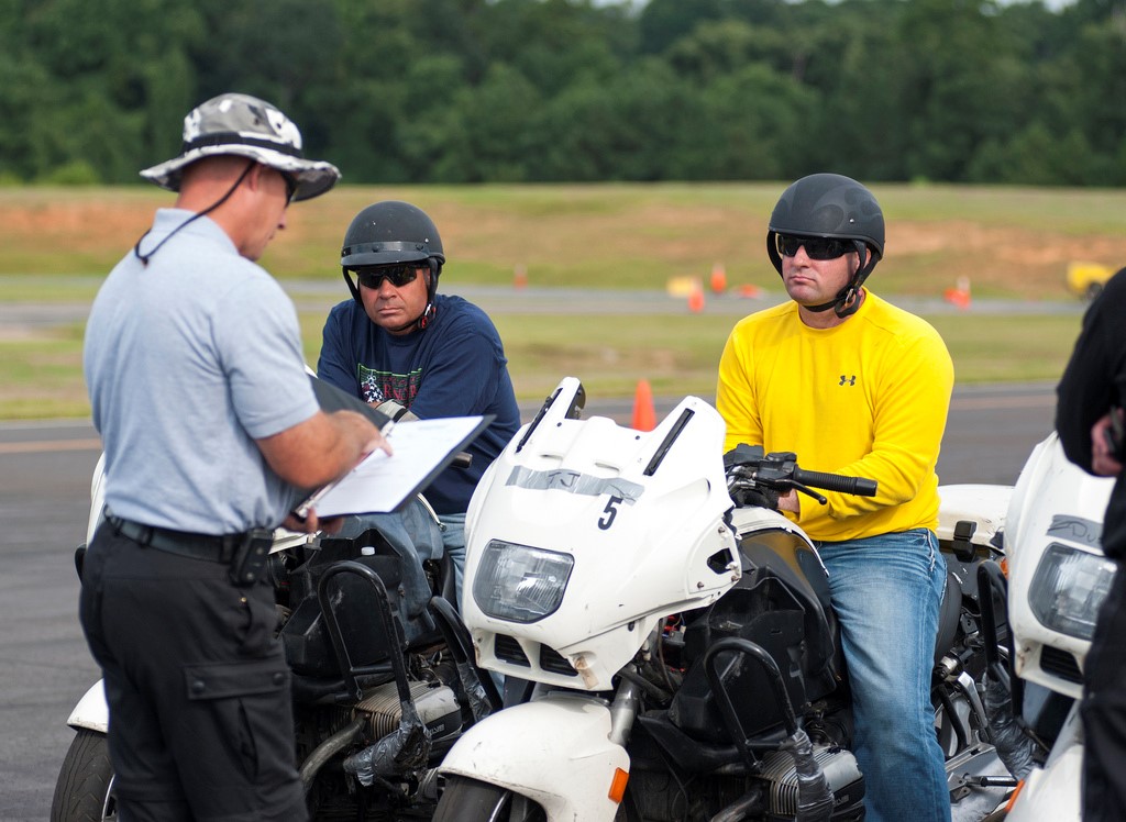 Investigator surveying motorcyclists on sport bikes